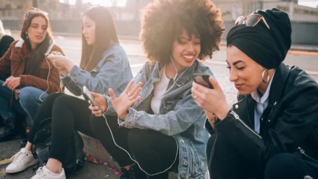 Ladies sitting on the pavement